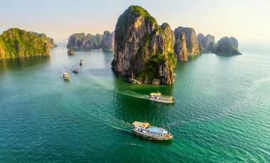 Aerial view floating fishing village and rock island, Halong Bay, Vietnam, Southeast Asia. UNESCO World Heritage Site. Junk boat cruise to Ha Long Bay. Popular landmark, famous destination of Vietnam