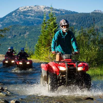 a man riding a motorcycle down a river