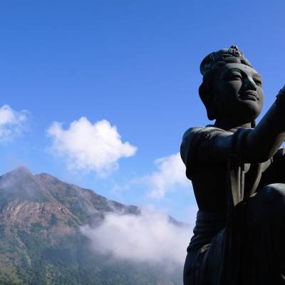 a person standing in front of a mountain