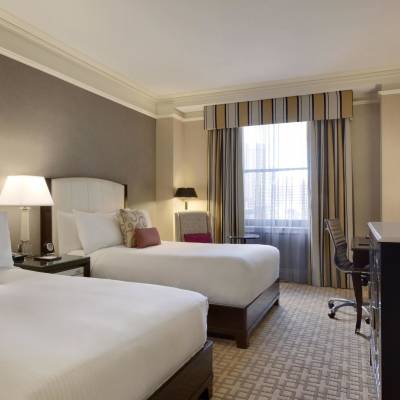 a bedroom with a large bed in a hotel room