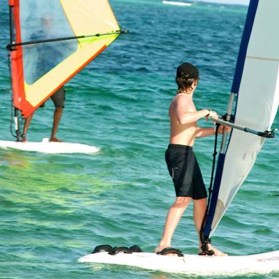 a person riding a surf board on a body of water