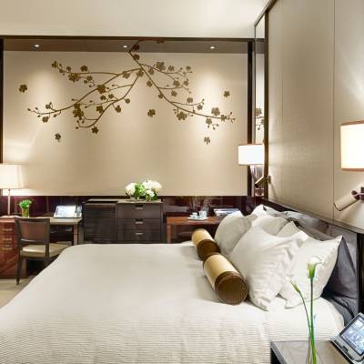 a bedroom with a bed and a mirror in a room