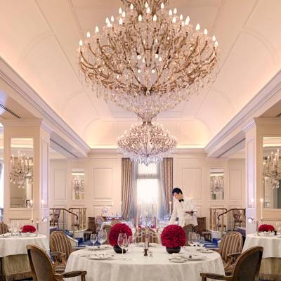 a living room filled with furniture and vase of flowers on a table