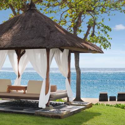 a couple of lawn chairs sitting next to a pool of water