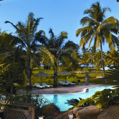 a palm tree in front of a building