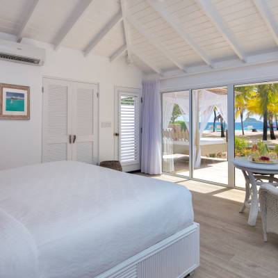 a bedroom with a bed and a chair in a room