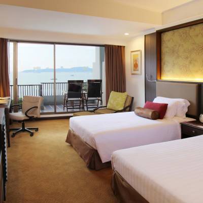 a bedroom with a bed and desk in a hotel room