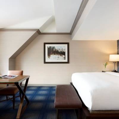 a hotel room with a bed and chair