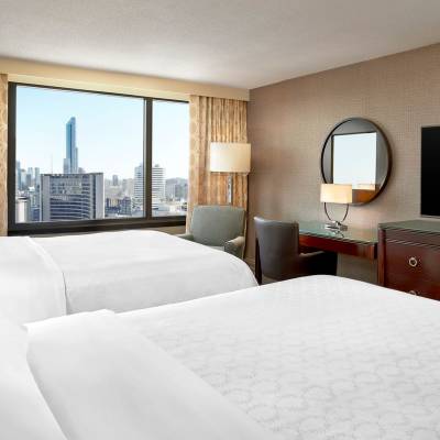 a bedroom with a large bed in a hotel room