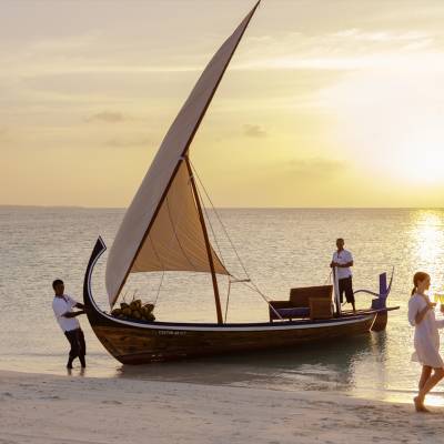 a group of people in a boat on the beach