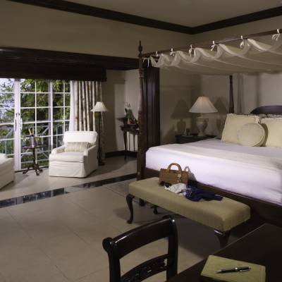 a bedroom with a bed and desk in a room