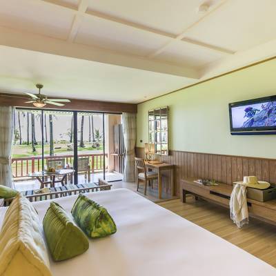 a bedroom with a large bed sitting in a living room