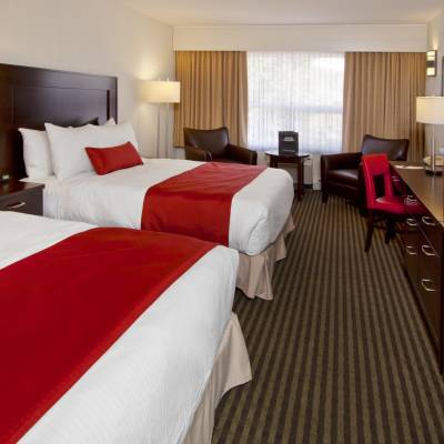 a bedroom with a large bed in a hotel room