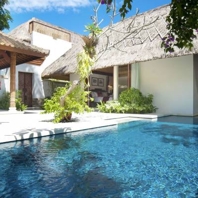 a house with a pool outside of a building