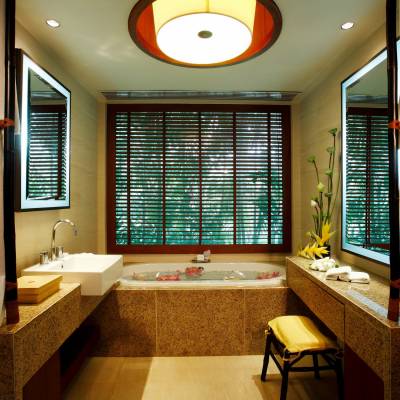 a hotel room with a sink and a window