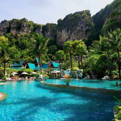 a pool next to a body of water with Phi Phi Islands in the background