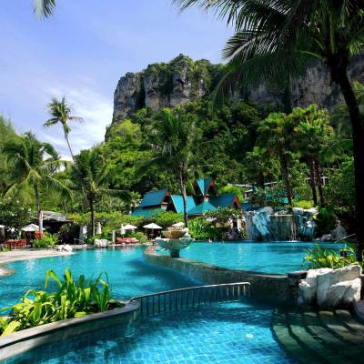 a resort near the water lined with palm trees