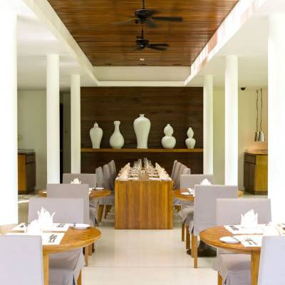 a dining room filled with furniture and vase on a table