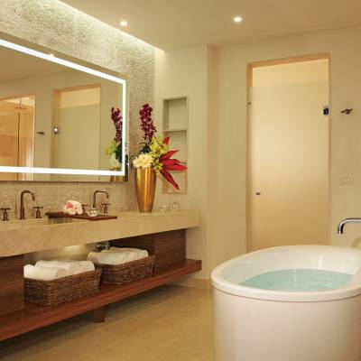 a white sink sitting under a mirror