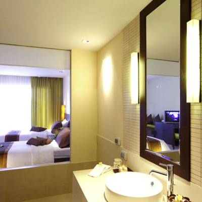 a hotel room with a sink and a mirror