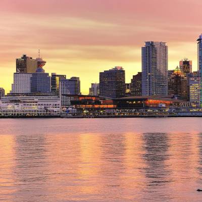 a large body of water with a city in the background