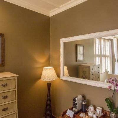 a bedroom with a bed and a mirror in a room