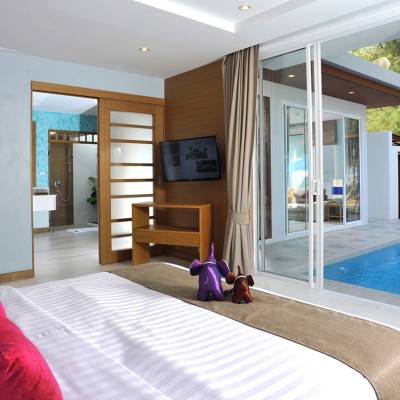 a large white bed sitting in a room
