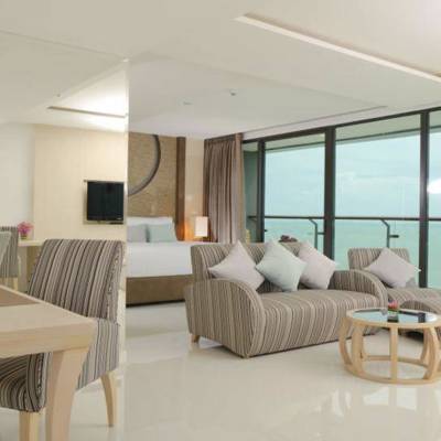 a bedroom with a bed and a chair in a room