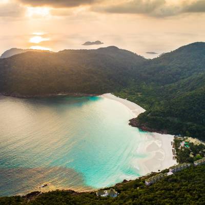 a large body of water with a mountain in the background