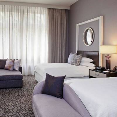 a bedroom with a large bed in a hotel room