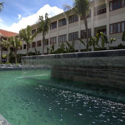 a house with a pool in front of a building