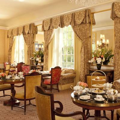 a living room filled with furniture and vase of flowers on a table