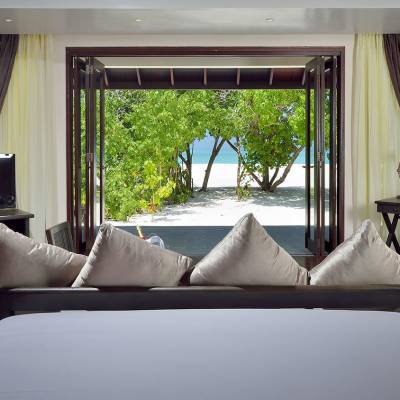 a living room with a bed and a window