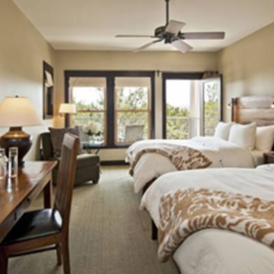 a bedroom with a bed and a chair in a room