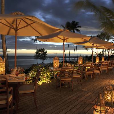 a row of beach chairs and an umbrella