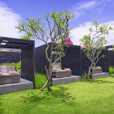 a couple of lawn chairs sitting on top of a grass covered field