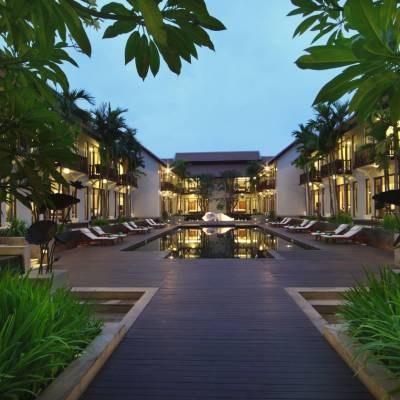 a building next to a palm tree