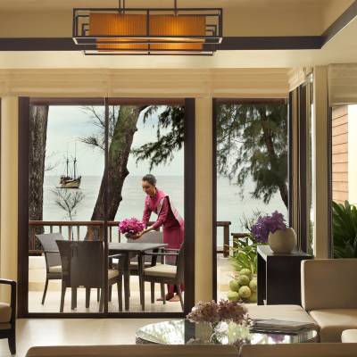 a living room filled with furniture and vase of flowers on a table