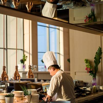 a man and a woman sitting at a table in front of a window