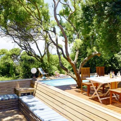 an empty park bench next to a wooden fence