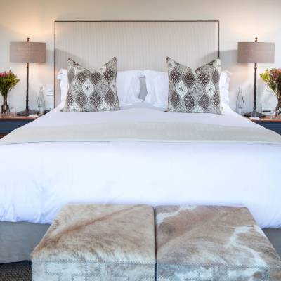 a bedroom with a neatly made bed in a hotel room