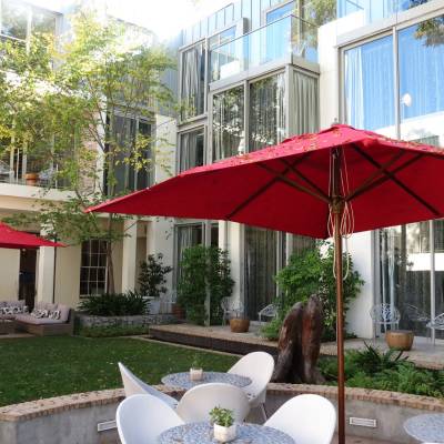 a red umbrella in front of a building