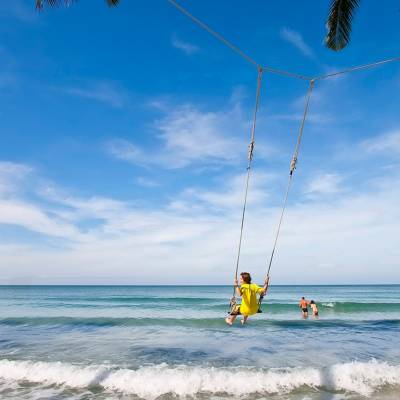 a man flying a kite on the beach