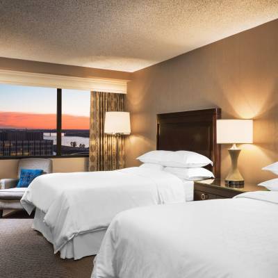 a bedroom with a large bed in a hotel room