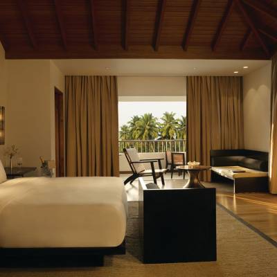 a bedroom with a bed and a chair in a room