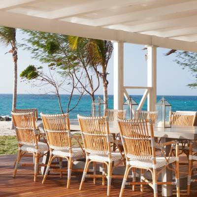 a group of lawn chairs sitting on top of a wooden table