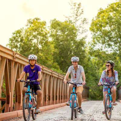 a group of people riding on the back of a bicycle