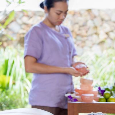 a person standing in front of a fruit stand