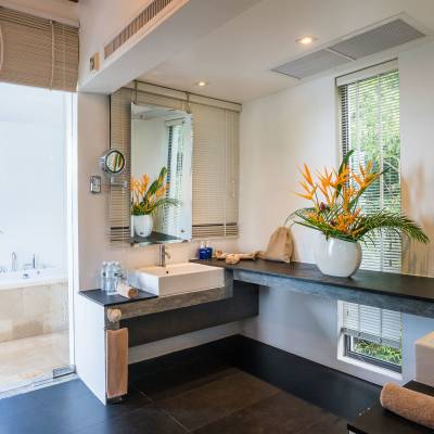 a room filled with furniture and vase of flowers on a table