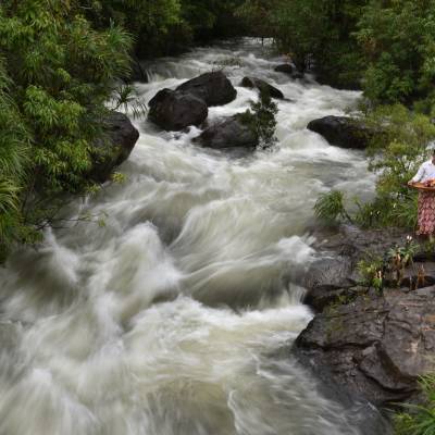 a person standing next to a waterfall